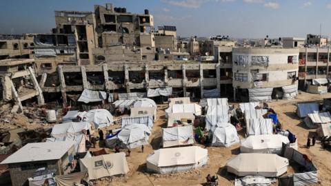 Tents for displaced Palestinians are set up near destroyed and heavily damaged buildings in Gaza City (26 February 2025)