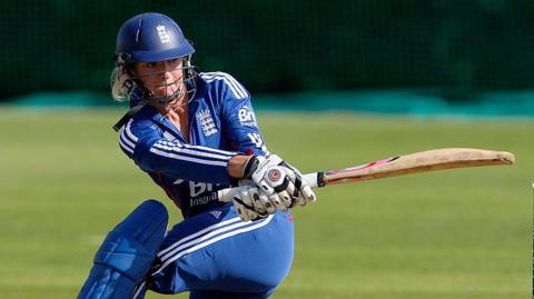 Susie Wilson-Rowe swings the bat while playing for England