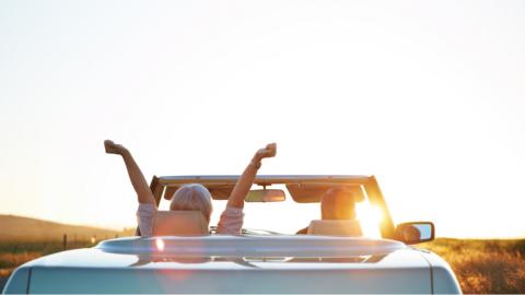 Two people in a soft top