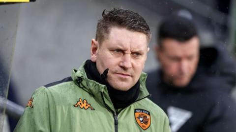 Hull City coach Andy Dawson looks on from the touchline.