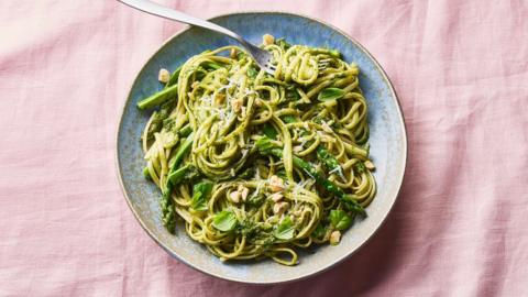A bowl of pasta with hazelnut pesto and asparagus