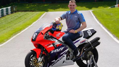 Nathan Harrison sitting on the Ashcourt Racing Honda RC45