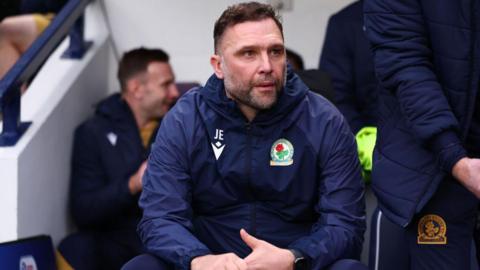 John Eustace, sat in the Blackburn dugout