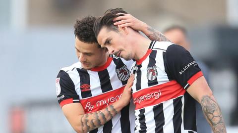 Grimsby two players hug