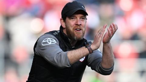 Darrell Clarke claps from the touchline during his time in charge of Barnsley