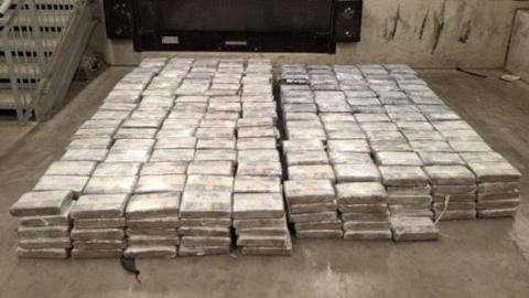 Dozens of packages of cocaine piled up on the floor