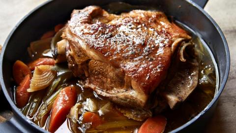 Roast lamb with vegetables in a deep pan