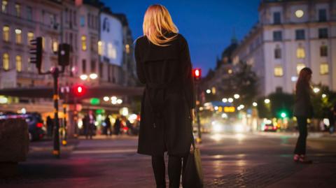 Woman walking alone at night