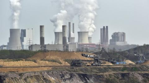 Open-cast mining Garzweiler in front of a smoking power plant near the city of Grevenbroich in western Germany.