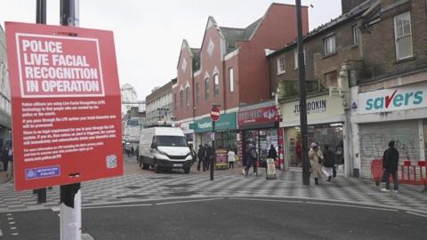 A red sign saying LFR camera is in use on a street in Croydon