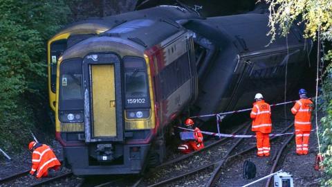 Investigators stood by trains at the scene of the crash