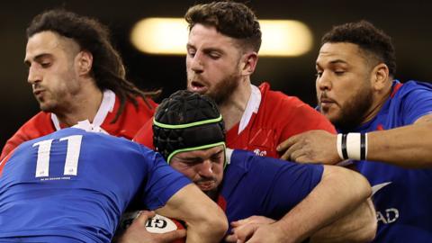 Gregory Alldritt of France is tackled by Josh Navidi and Alex Cuthbert of Wales