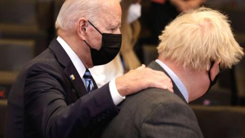 US President Joe Biden (L) greets Britain's Prime Minister Boris Johnson at Nato summit headquarters in Brussels, 14 June 2021