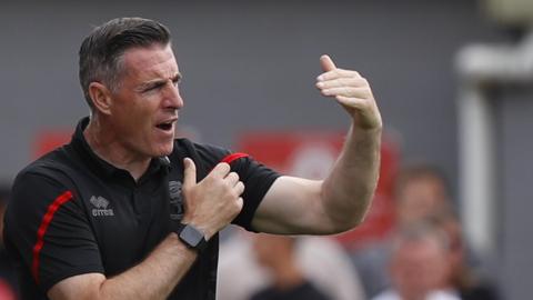 Lincoln City boss Mark Kennedy addresses his players from the sideline