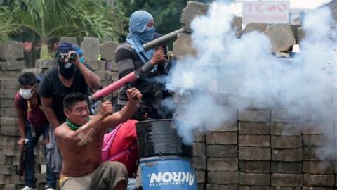 A demonstrator fires a homemade weapon against police during a protest against the government of Nicaraguan President Daniel Ortega in Masaya, Nicaragua June 19, 2018