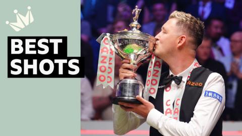 Kyren Wilson kisses the World Snooker Championship trophy