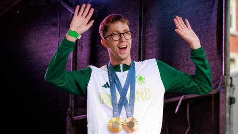 Daniel Wiffin in Ireland kit wearing two medals