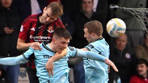 Action from the Boxing Day encounter between derby rivals Crusaders and Cliftonville