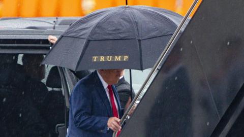 Former US President Donald Trump boards his private airplane at Ronald Reagan National Airport (DCA) in Arlington, Virginia, US, on Thursday, Aug. 3, 2023. 