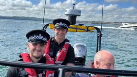 Police officers on a boat