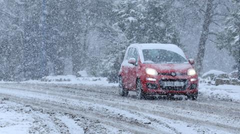 car on very snowy road