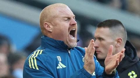 Sean Dyche, in club tracksuits, applauds as he encourages Nottingham Forest