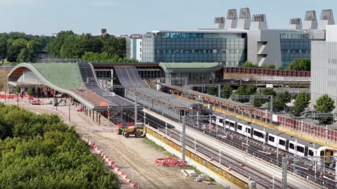A drone image of the new Cambridge South station with a Great Northern train on the platform