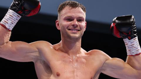 Lewis Richardson pictured after the fight, holding his arms aloft