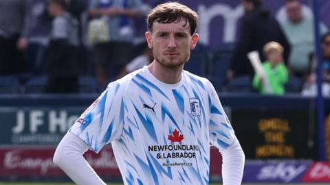 Joe Anderson stood with his hands on his hips after Barrow are relegated to the National League