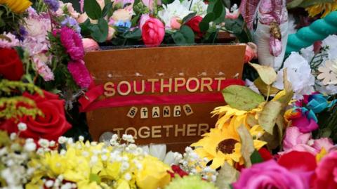 Floral tributes left by members of the public are seen following the fatal knife attack on three young girls in July in Southport