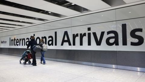 Airline passengers in the arrivals hall at Heathrow Airport in London