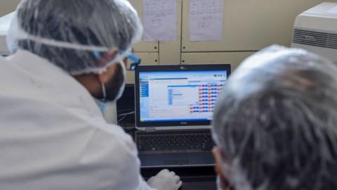 Employees of Dr Lal PathLabs, that provides diagnostic and health tests, check results of coronavirus tests at their lab during a government-imposed nationwide lockdown as a preventive measure against the COVID-19 coronavirus, in New Delhi on April 2, 2020.