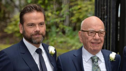 Lachlan and Rupert Murdoch pose together for a photograph at a wedding 
