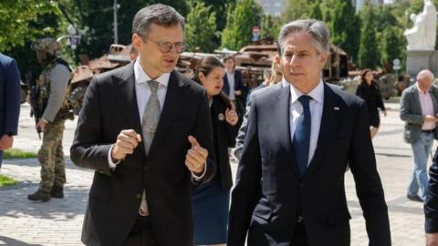 Ukrainian Foreign Minister Dmytro Kuleba (C-L) and US Secretary of State Antony Blinken (C-R) talk during their walk in downtown Kyiv, Ukraine, 15 May 2024