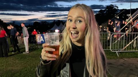 Darcy posing with a glass of beer