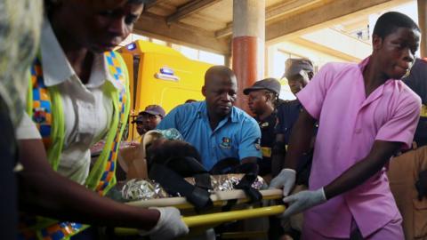 Medics transport an injured person after Lagos school collapse - 13 March 2019