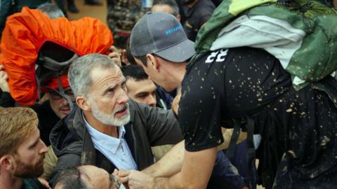 King Felipe talks with a person