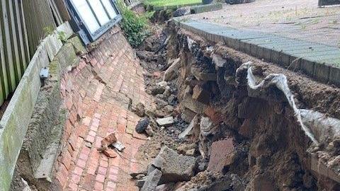 A hole left by the collapsed wall at the property