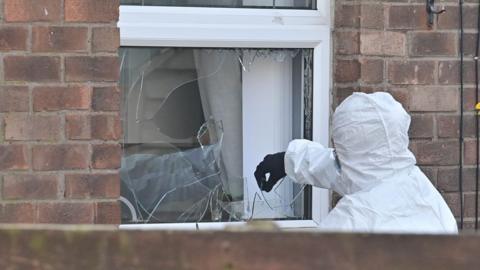 A forensic officer in Moyne Gardens in Newtownards after two petrol bombs were thrown at a house