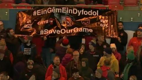 Fans with a banner on display at Parc y Scarlets