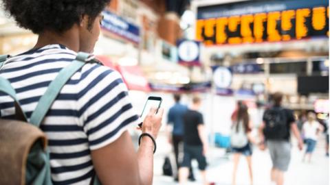 passenger and phone on train platform