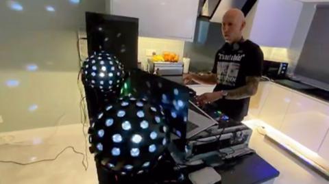 DJ with decks in kitchen