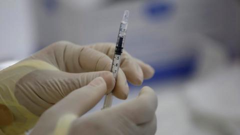 Medical personnel prepare a Pfizer vaccine against covid-19 during a day of applying second doses to the population, at the Manuel Jose Hurtado school, in the Chorrillo neighborhood in Panama City, Panama, 21 April 2021.