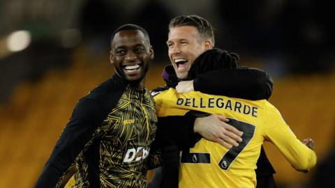 Rob Edwards celebrates with Toti Gomes and Jean-Ricner Bellegarde