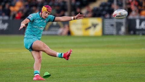 Huddersfield Giants player George Flanagan kicks a conversion against Castleford Tigers.