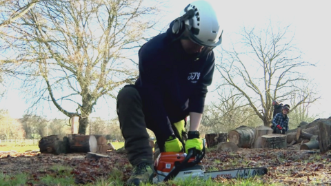 Student holding a chainsaw