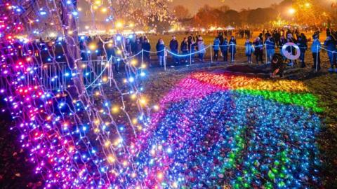 The Waterfall of Lights display created by Sola with a crowd gathered to see it