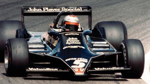 A wide-bodied Team Lotus F1 car being driven by Mario Andretti