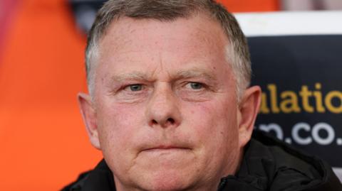 Stoke City boss Mark Robins looks on from the touchline