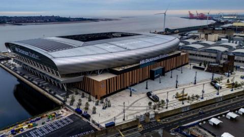 An aerial view of Hill Dickinson Stadium home of Everton FC. The River Mersey, dockland and the Wirral peninsula is in the background.